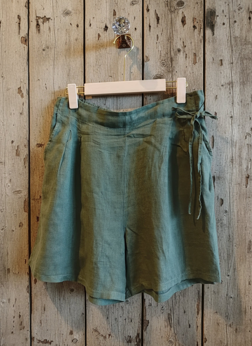 pair of linen short hanging on a wooden wall