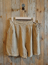 pair of linen short hanging on a wooden wall