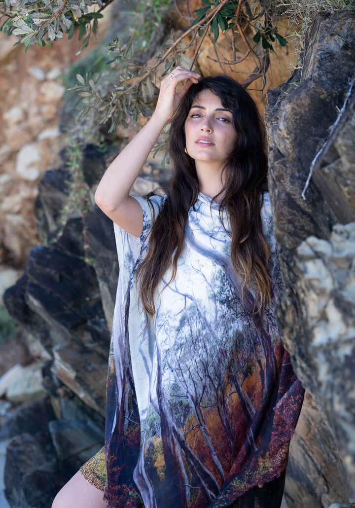 Woman wearing a SCARF printed with a fagus beech wood forest photograph with a natural stone background