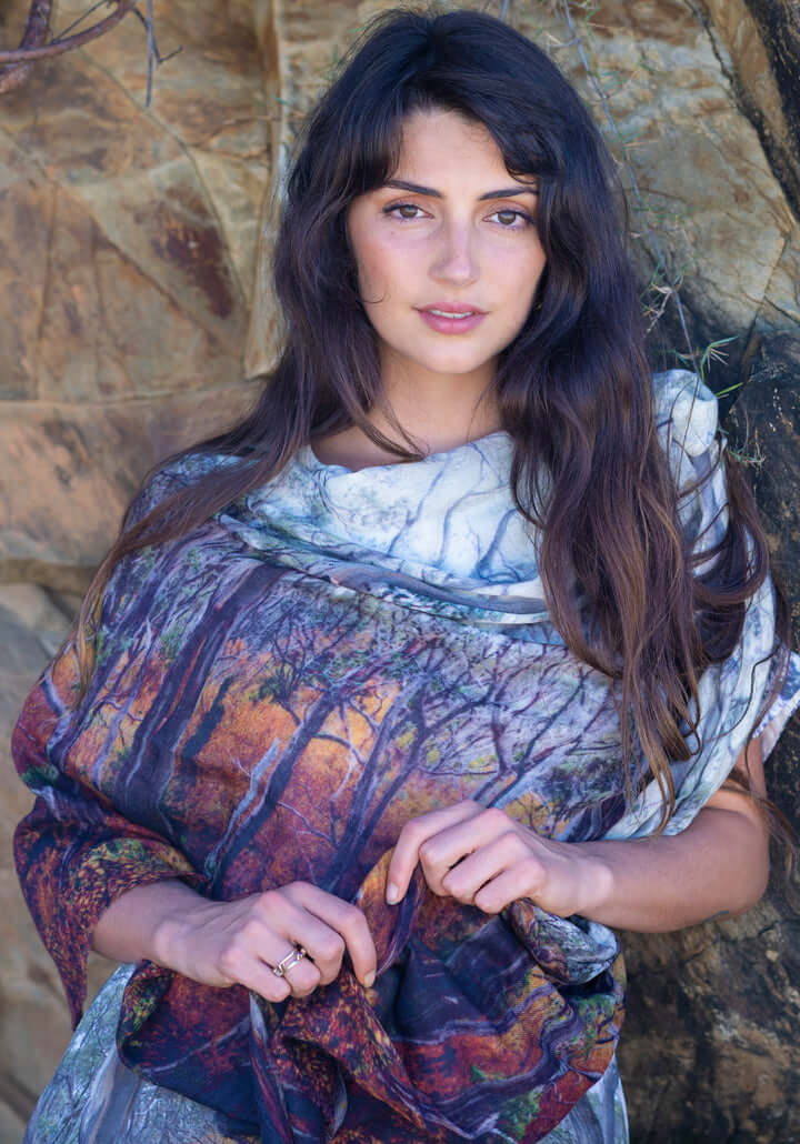 Woman wearing a SCARF printed with a fagus beech wood forest photograph with a natural stone background
