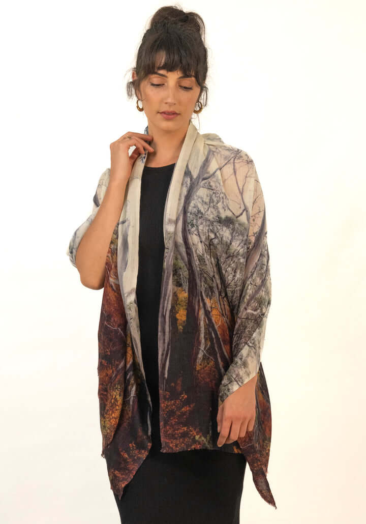 Woman wearing a SCARF printed with a fagus beech wood forest photograph with a natural stone background