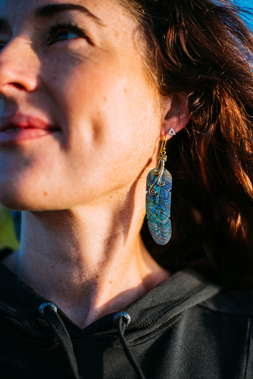 feather earring carved from paua shell with brass hook and swirl