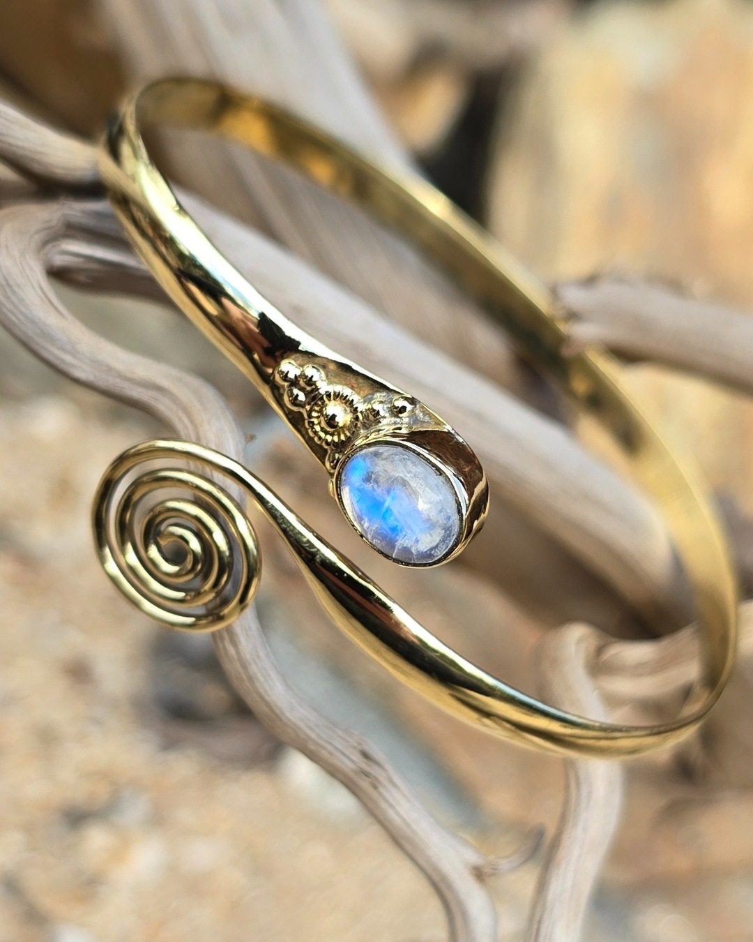 brass bracelet with swirl and moonstone gem