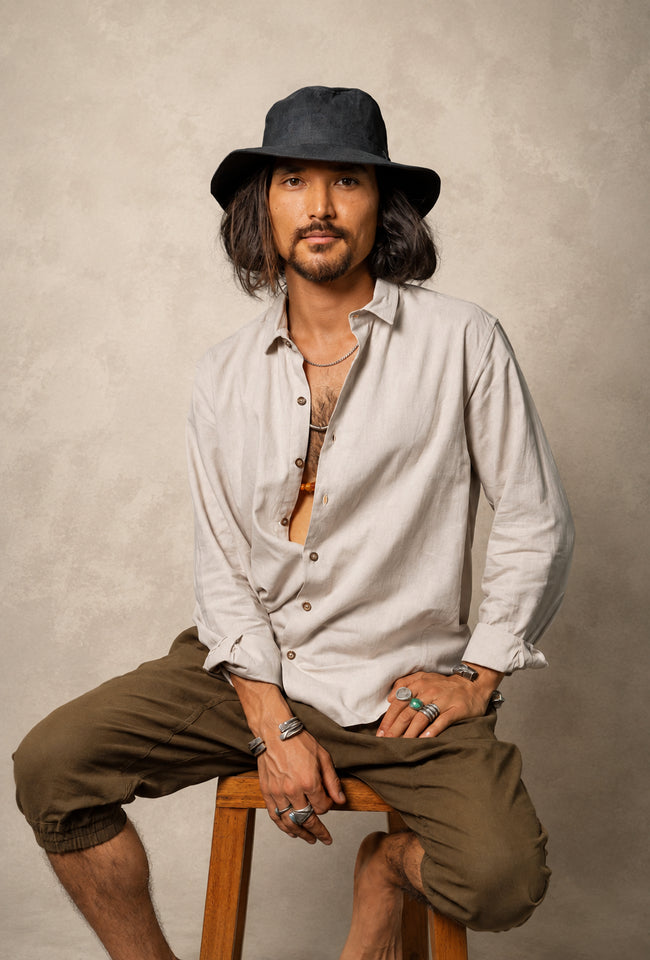 Hemp Fedora Hat in black organic hemp with a medium brim and UV protection worn outdoors.