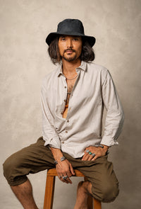 Hemp Fedora Hat in black organic hemp with a medium brim and UV protection worn outdoors.