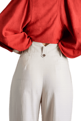 Red shirt and white pants against a white background