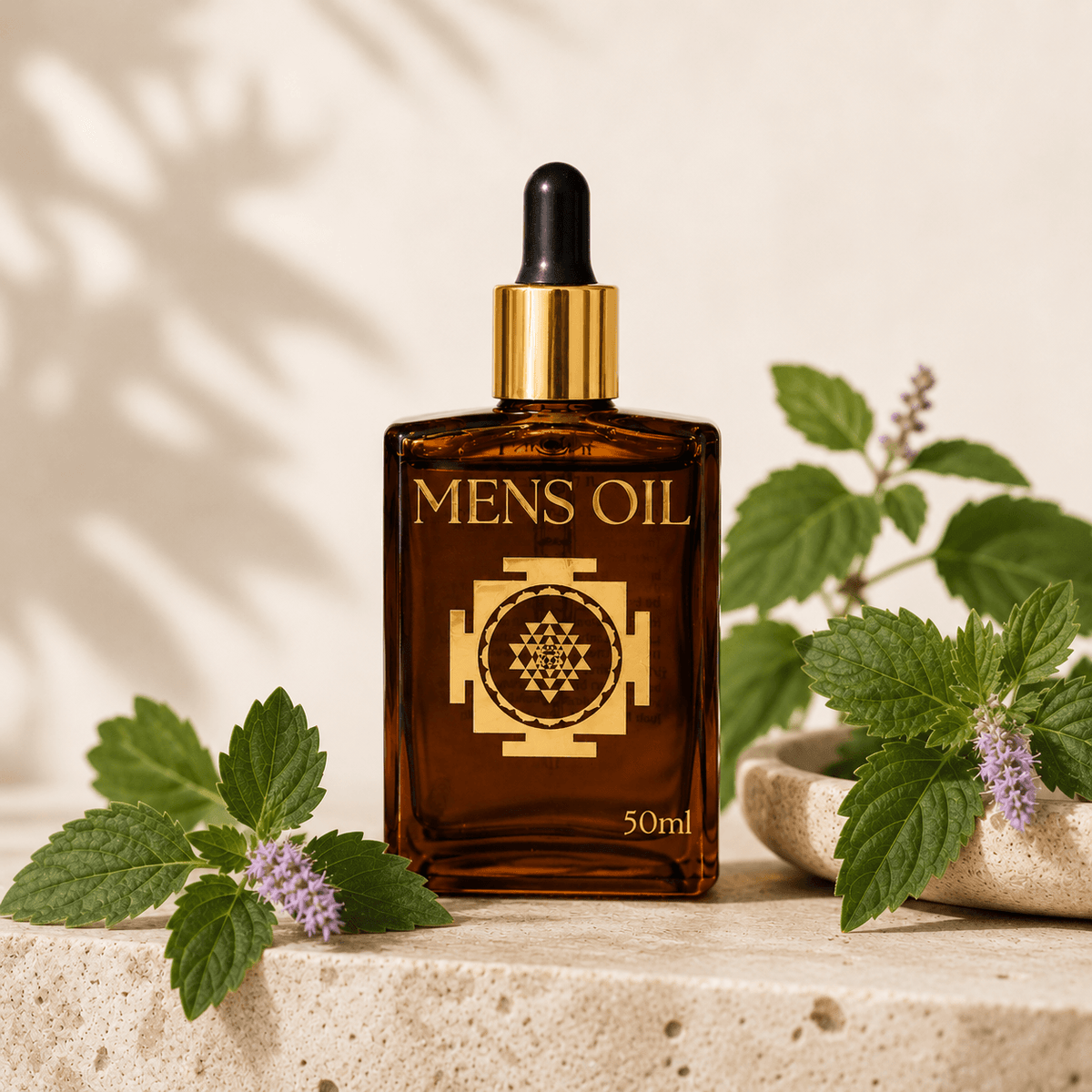 Bottle of 'Mens Oil' with a dropper on a stone surface with green leaves.