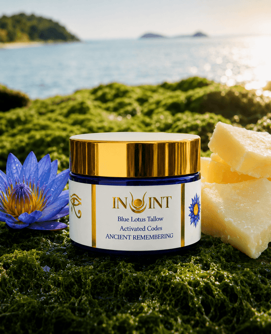 Jar of Blue Lotus Tallow with a blue flower and soap on green grass by a body of water