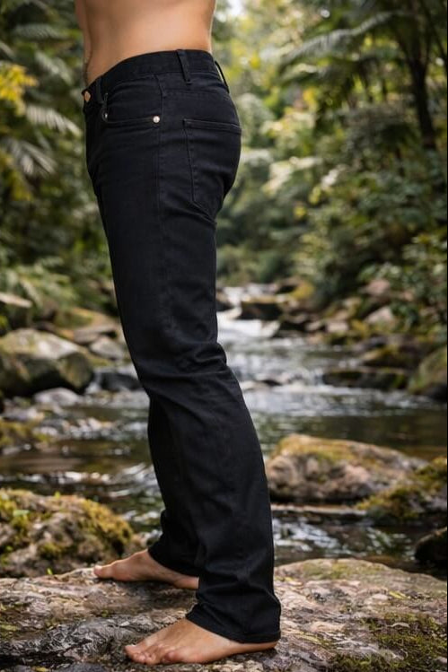Person wearing black pants standing on a rock with a natural background