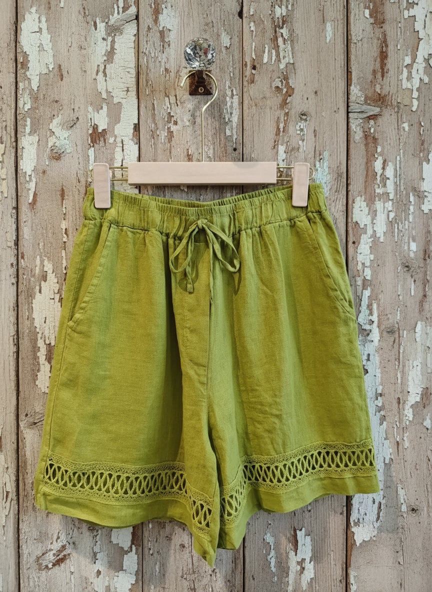 pair of pistachio colour shorts hanging on a wall
