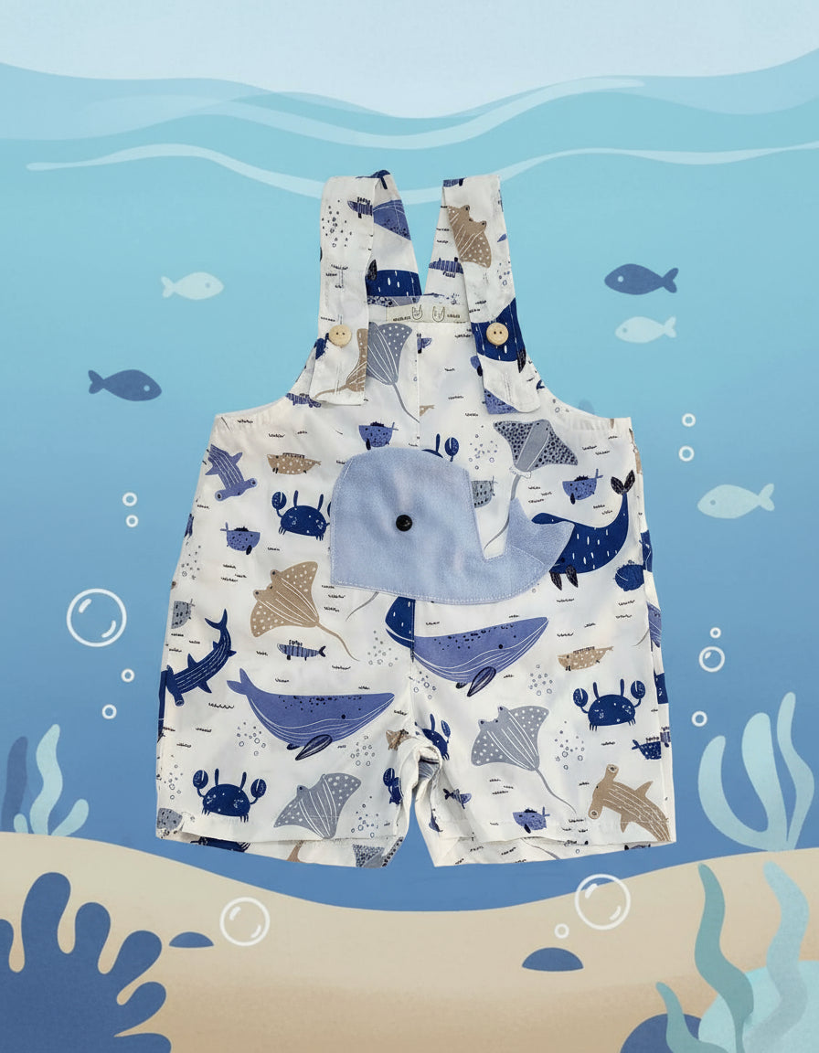 Children's romper with whale pattern on a gray background