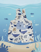 Children's romper with whale pattern on a gray background