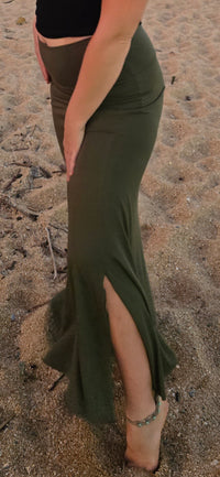 bottom hlaf of lady wearing green skirt at the beach