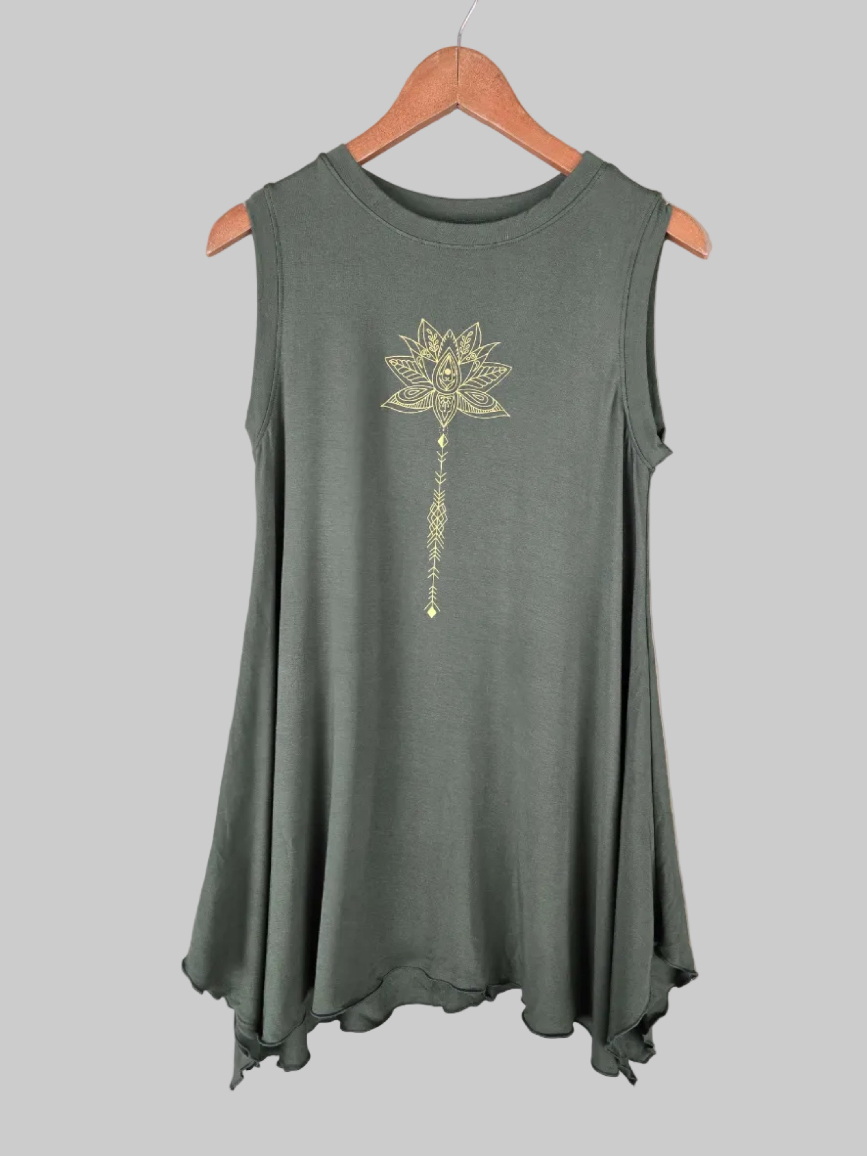 Green sleeveless top with a floral design on a hanger against a tiled wall.