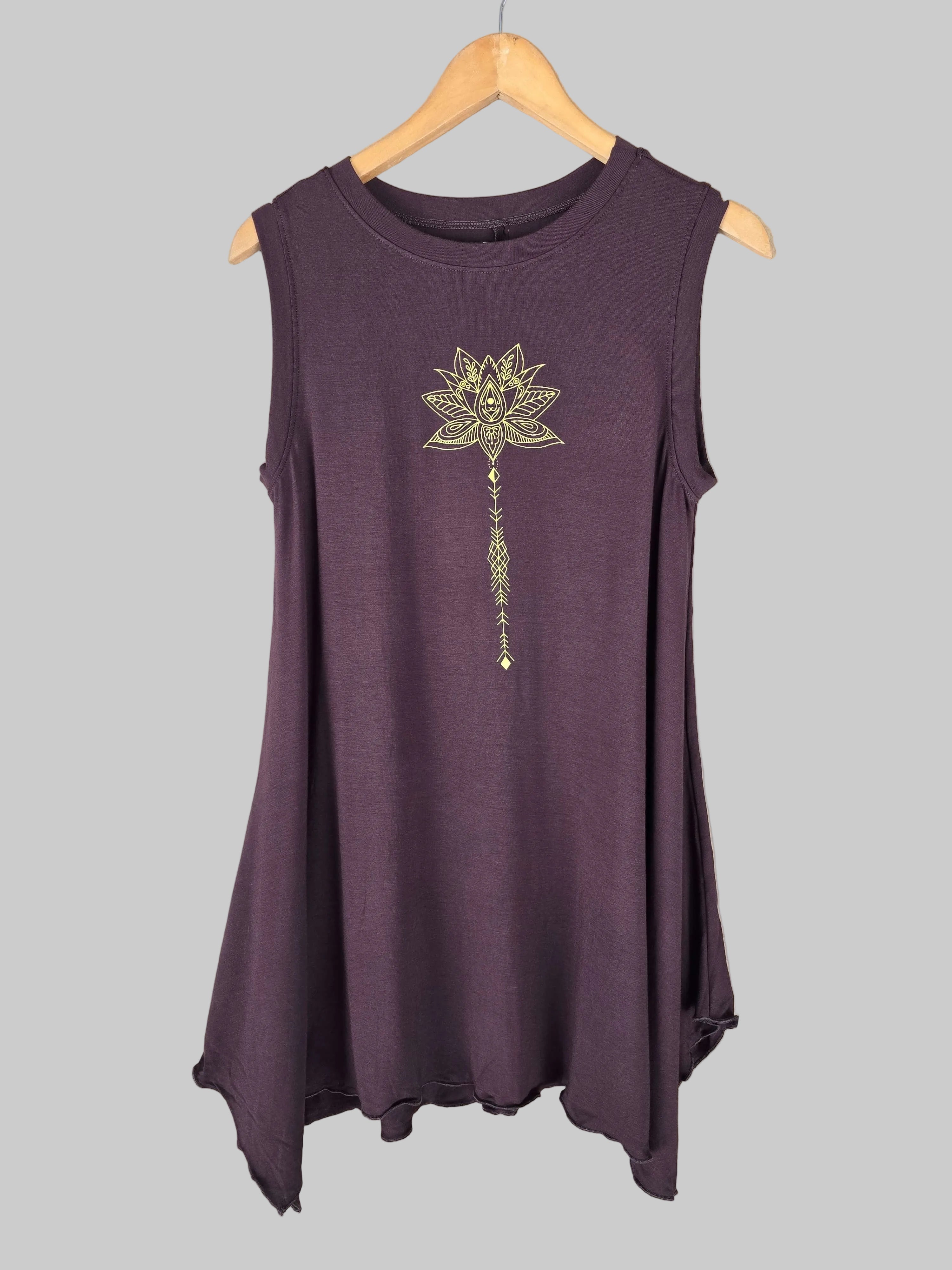 chocolate tunic decorative flower design on a hanger against a tiled wall.