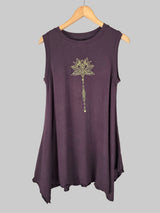 chocolate tunic decorative flower design on a hanger against a tiled wall.