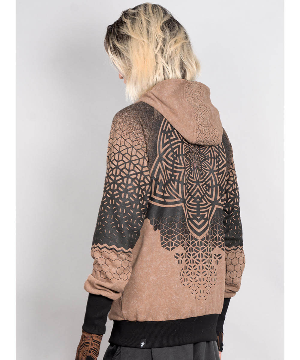 Person wearing a brown and black patterned hoodie on a white background