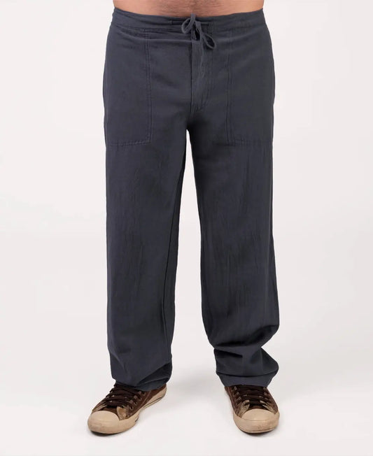 Dark gray pants worn by a person on a white background