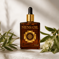 Bottle of 'Mens Oil' with a dropper on a light background with green leaves and flowers.