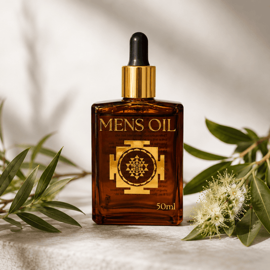 Bottle of 'Mens Oil' with a dropper on a light background with green leaves and flowers.