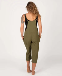 Person wearing a green jumpsuit with a black top on a white background