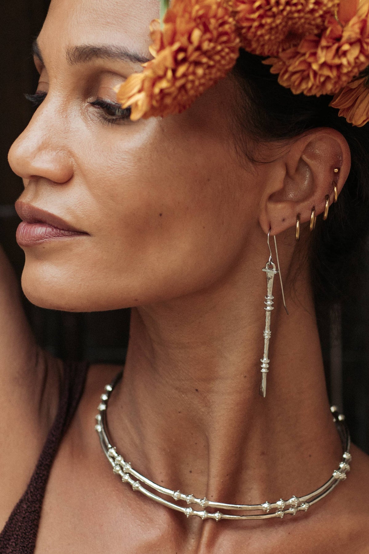 Nia Earrings worn as long textured white brass drop earrings