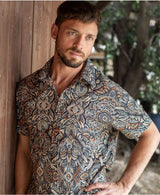 man in a psycadelic owl pattern button-up cotton shirt