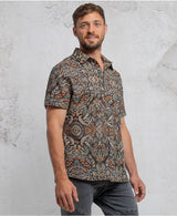man in a psycadelic owl pattern button-up cotton shirt