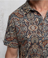 man in a psycadelic owl pattern button-up cotton shirt