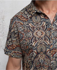 man in a psycadelic owl pattern button-up cotton shirt