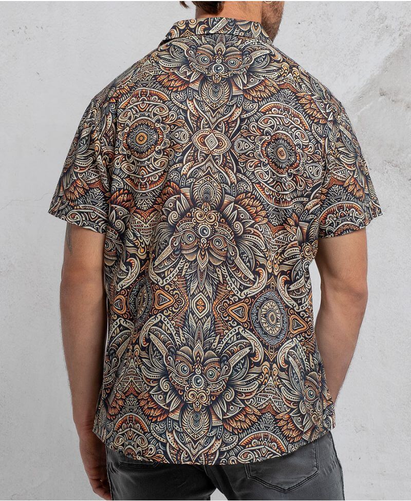 man in a psycadelic owl pattern button-up cotton shirt