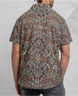 man in a psycadelic owl pattern button-up cotton shirt