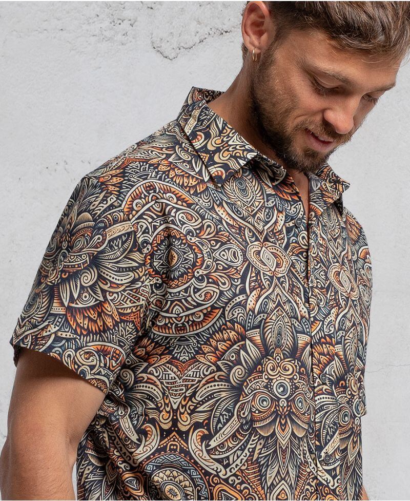 man in a psycadelic owl pattern button-up cotton shirt