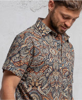 man in a psycadelic owl pattern button-up cotton shirt
