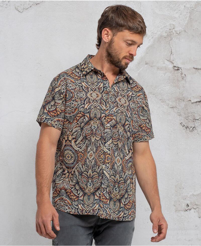 man in a psycadelic owl pattern button-up cotton shirt