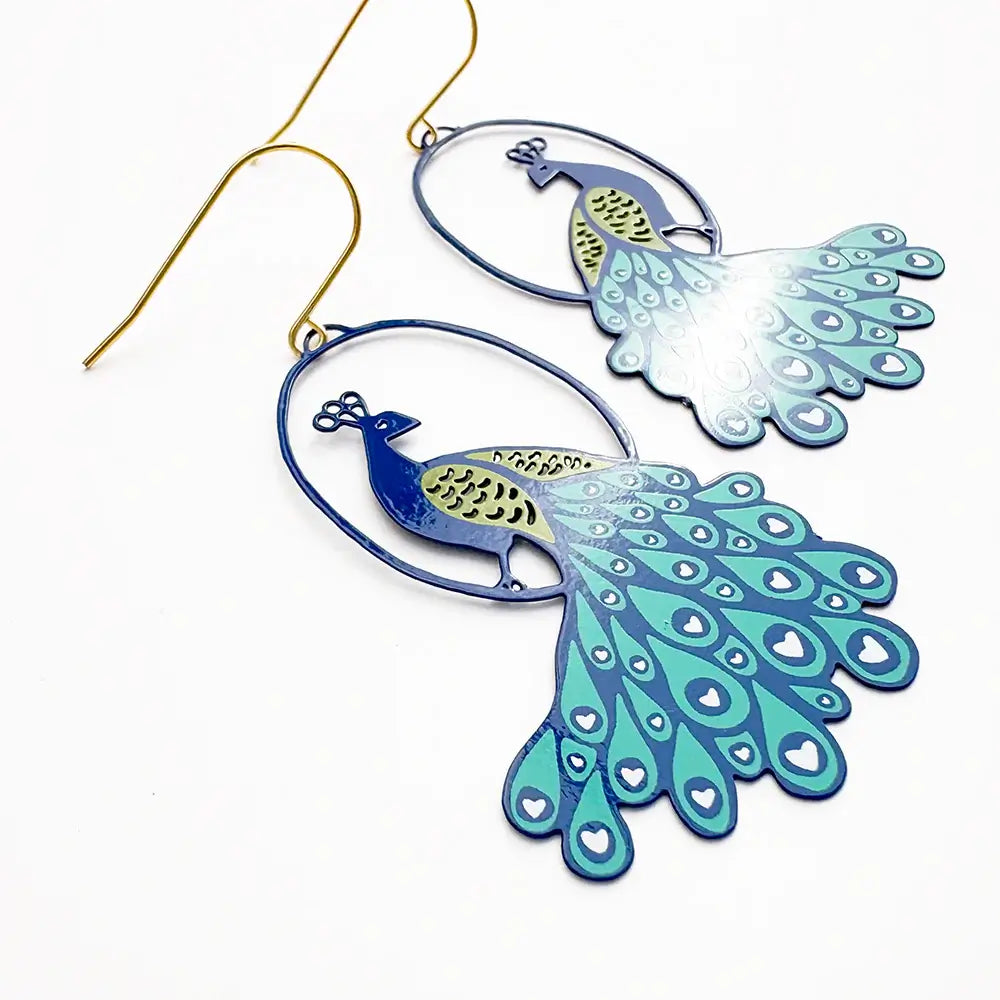 lady wearing earrings with peacock design 