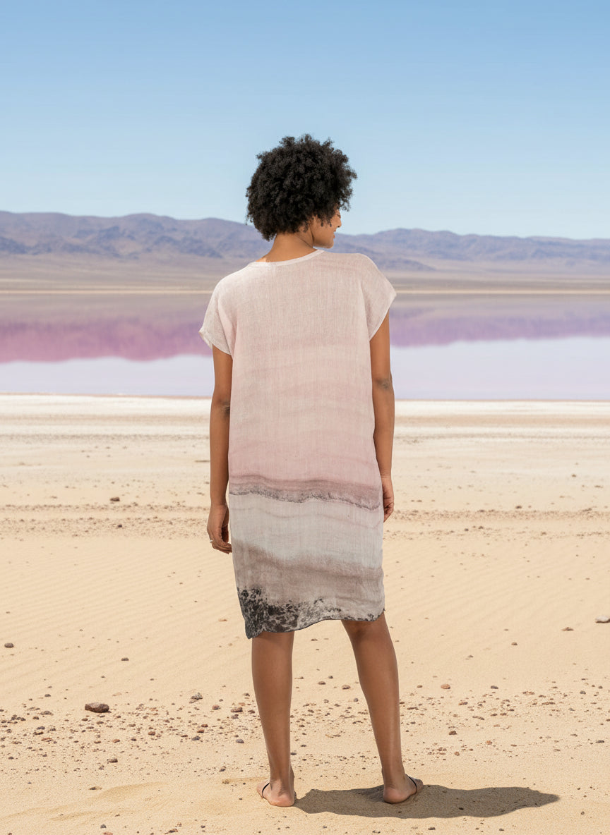 woman wearing a linen dress with pink salt lake print and a pink salt lake background