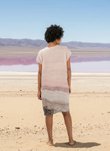 woman wearing a linen dress with pink salt lake print and a pink salt lake background