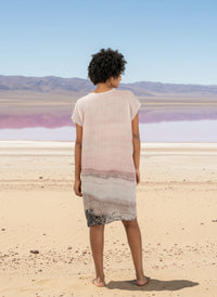 woman wearing a linen dress with pink salt lake print and a pink salt lake background