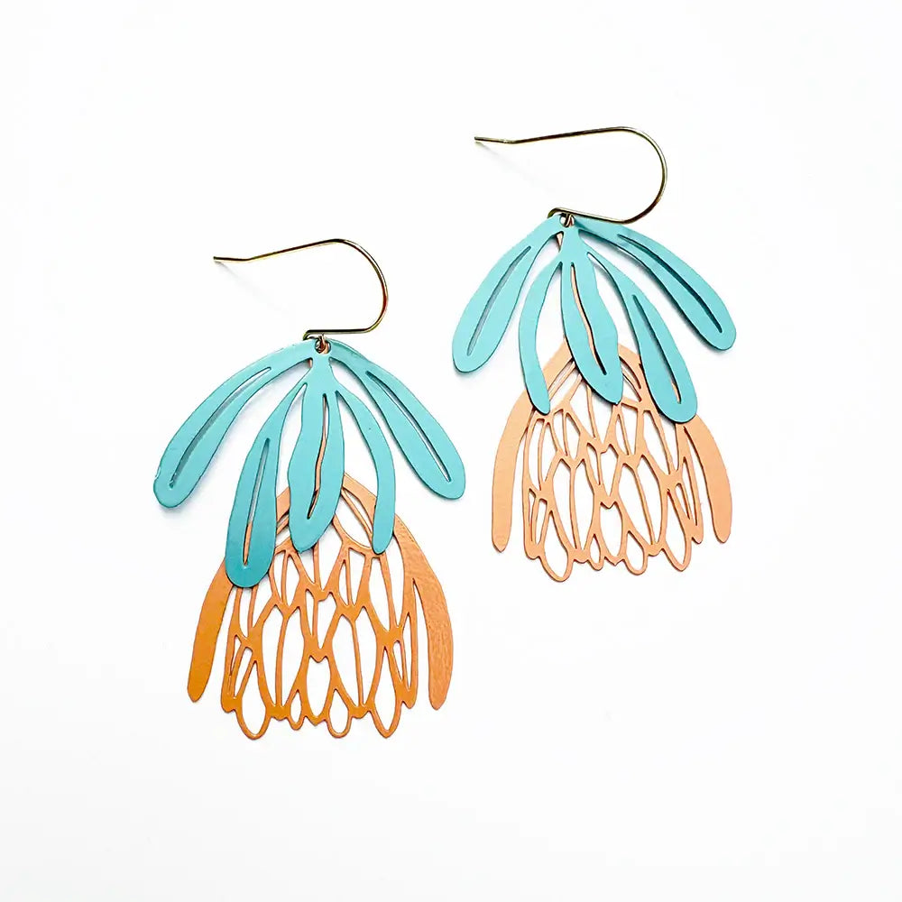 Pair of earrings with turquoise and orange design on a white background