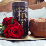 Harmoni Ritual product with red roses and a candle on a tray