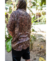 Person wearing a patterned shirt in a natural setting