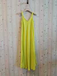 canary yellow dress haningn on the wall 
