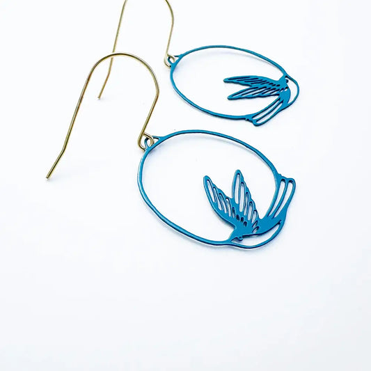 lady wearing blue swollow earrings