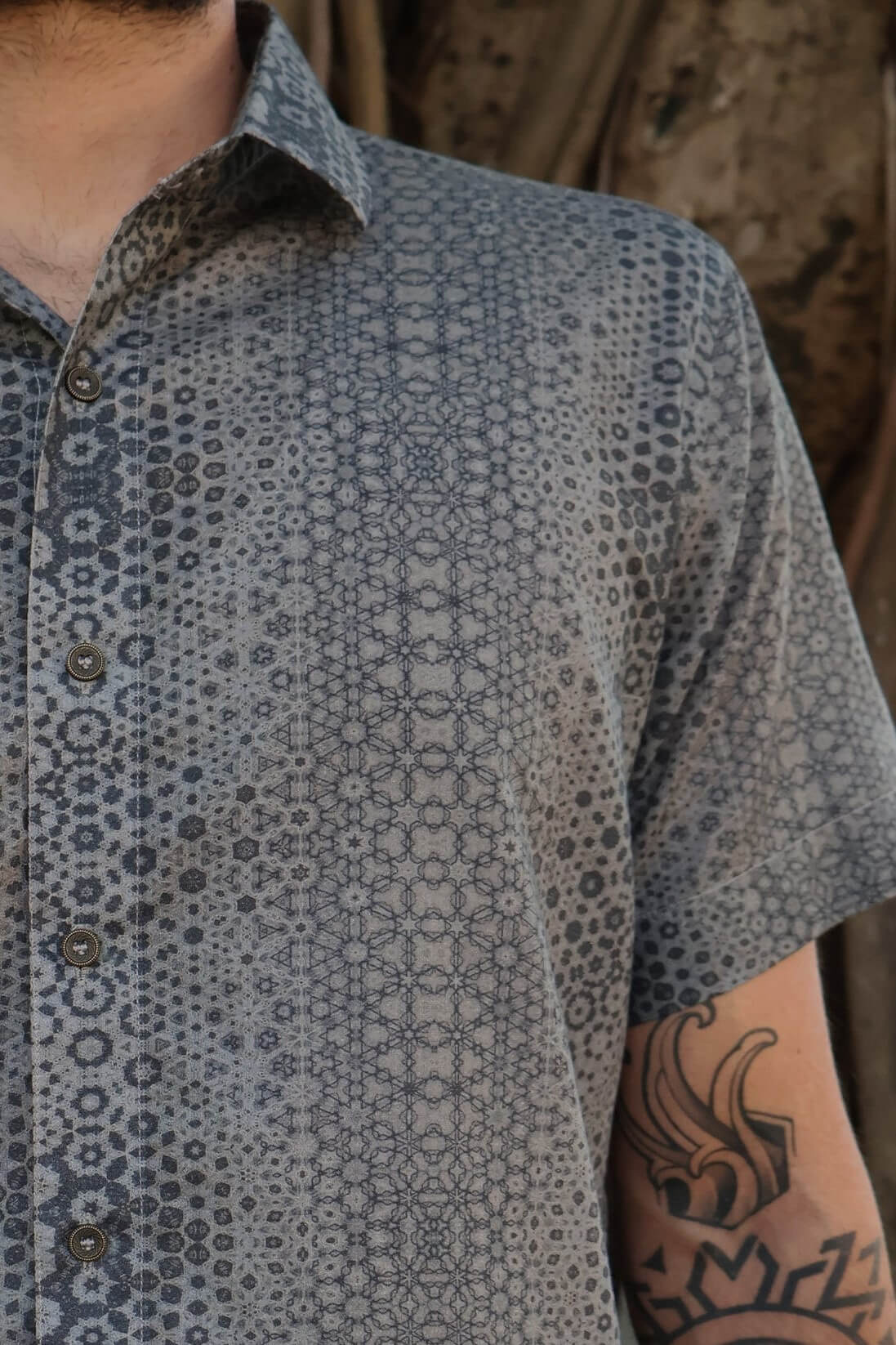 man in button up shirt with geometric print