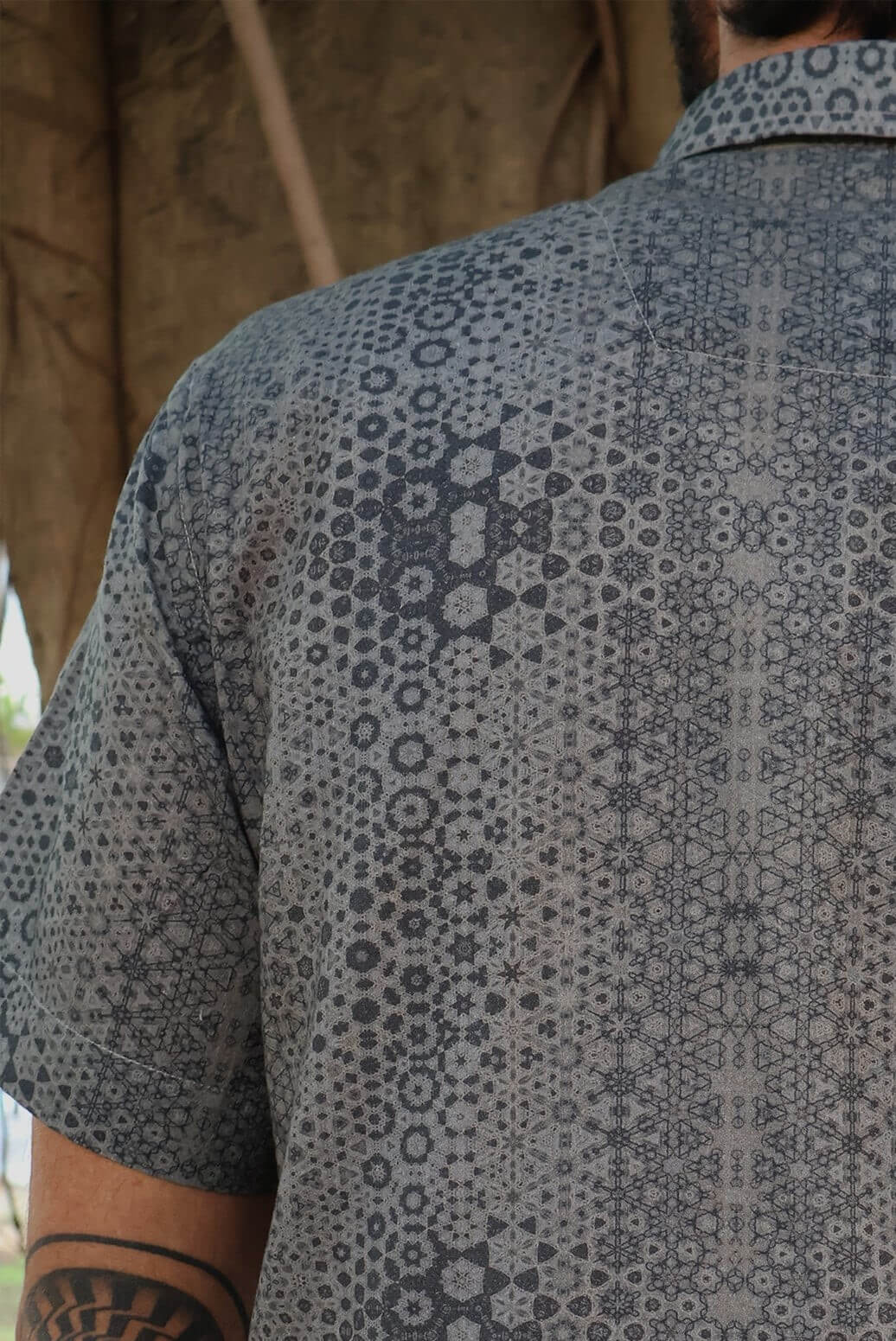 man in button up shirt with geometric print
