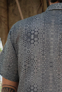 man in button up shirt with geometric print