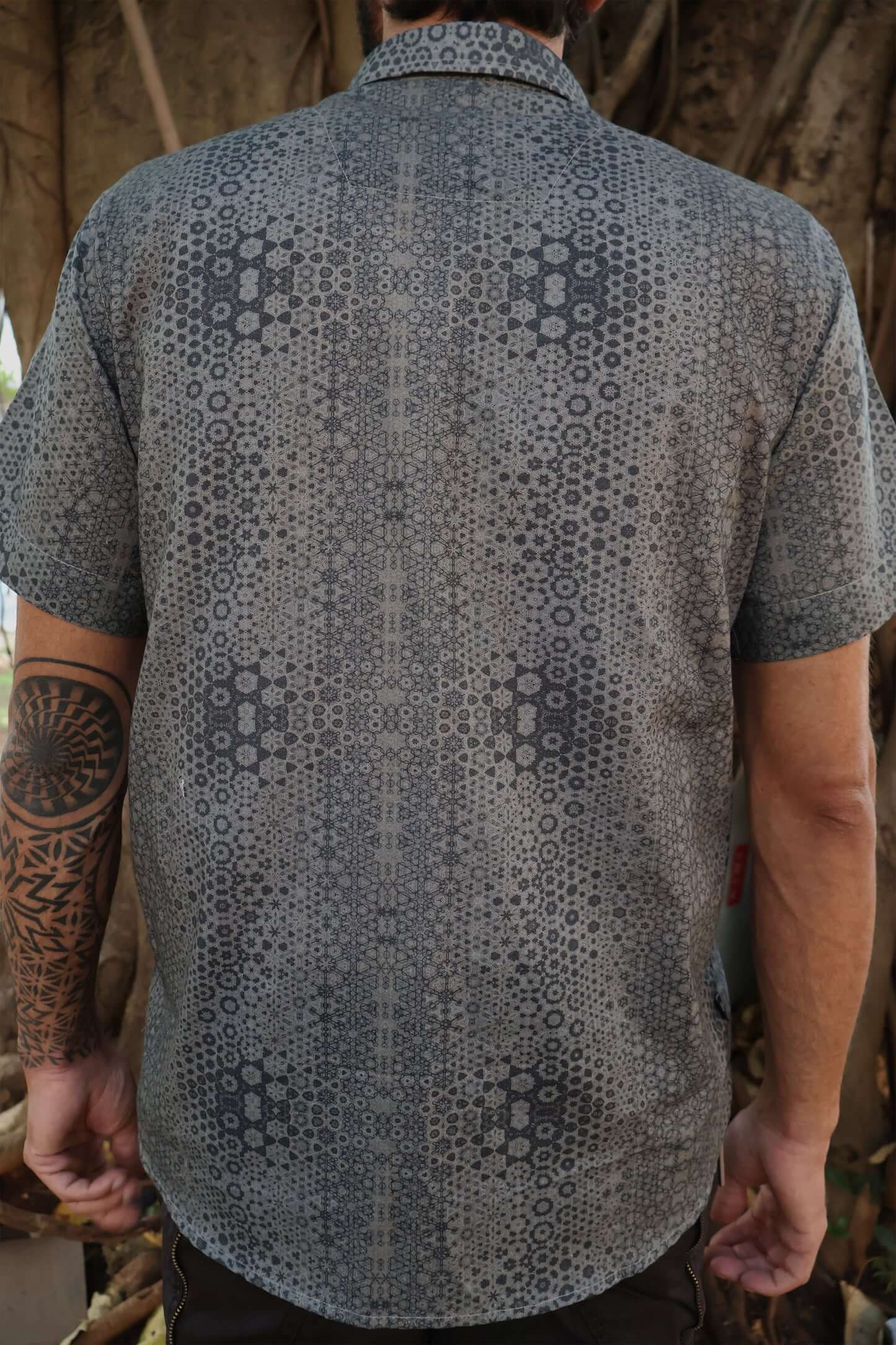 man in button p shirt with geometric print