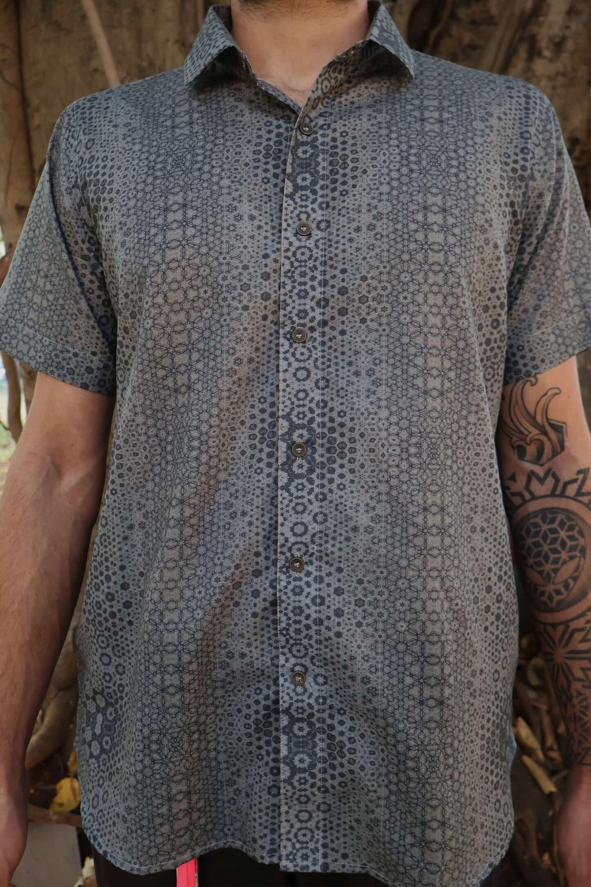man in button up shirt with geometric print