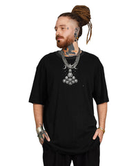 Man wearing a black t-shirt with a large necklace on a white background